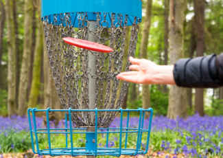 Image of a person throwing a disc golf disc